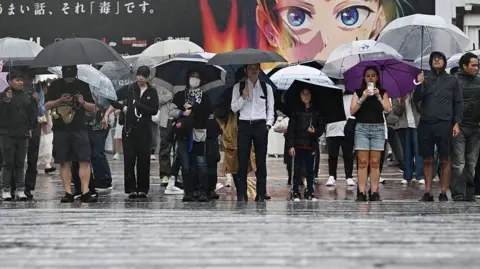 Japan warns of floods, landslides as Typhoon Dujuan nears Tokyo